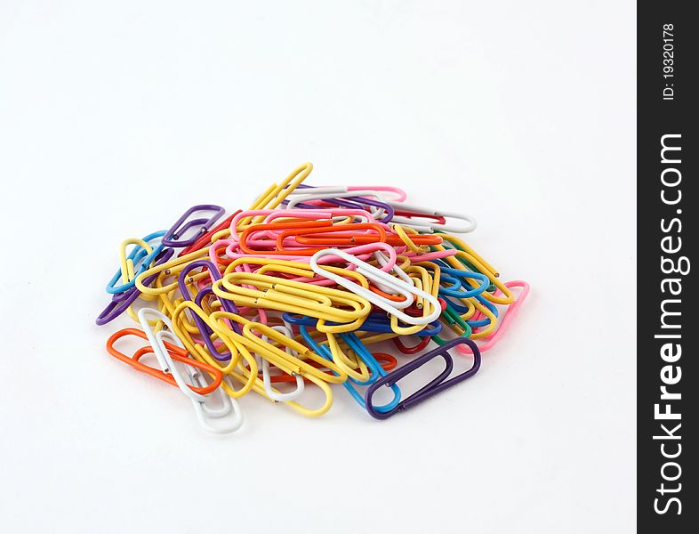 Colored paper clip on a white background