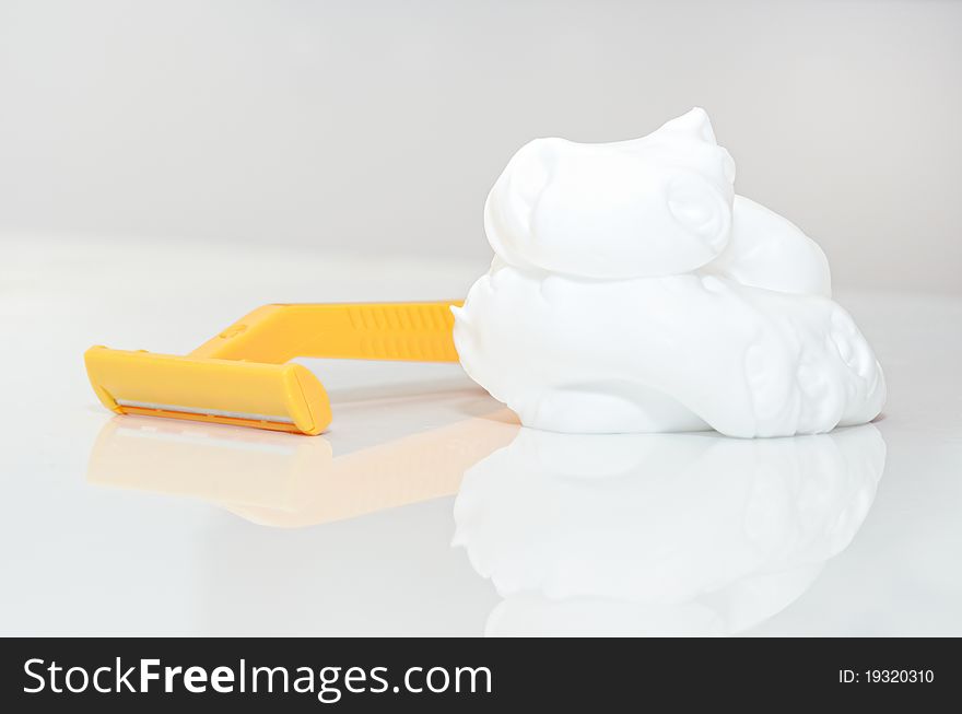 Razor and shaving foam isolated white backround