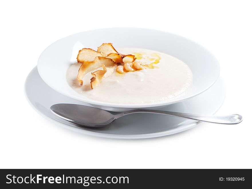 Cream soup from artichoke with shimps, crisp chips decoration isolated on white beackground. Cream soup from artichoke with shimps, crisp chips decoration isolated on white beackground