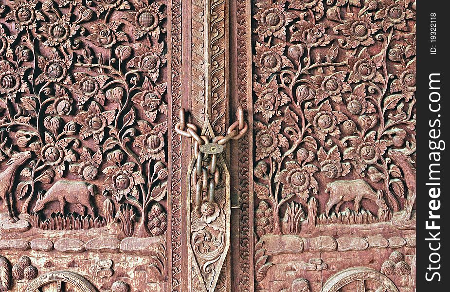 The Carving wood of door at temple. The Carving wood of door at temple