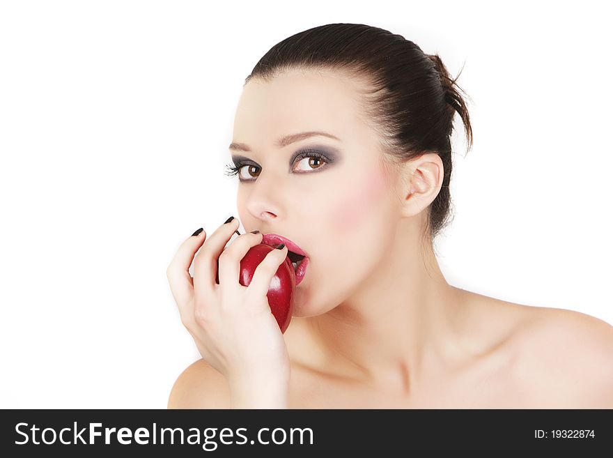 Studio portrait of young beautiful woman with red apple