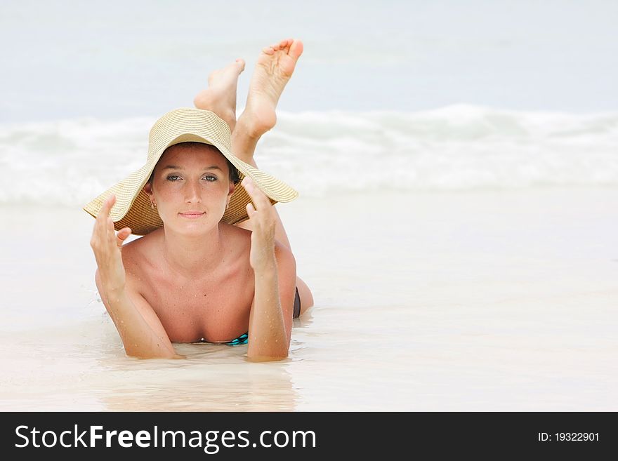 Young woman relaxing on beach. Young woman relaxing on beach