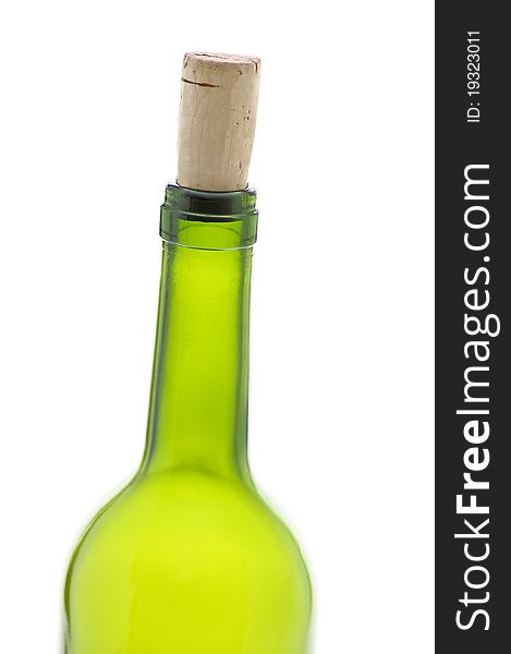 Closed wine bottle with a cork, against white