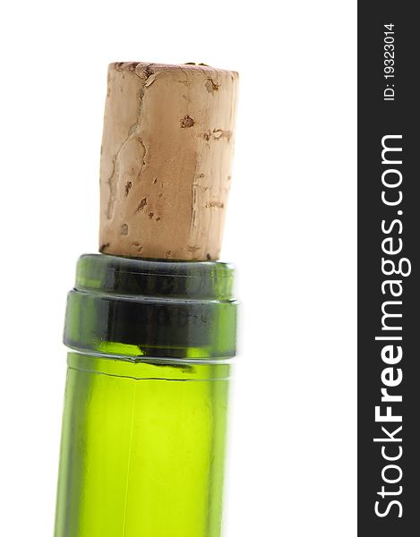 Closed wine bottle with a cork, against white