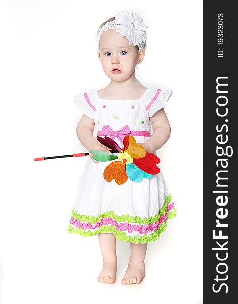 Beautiful toddler girl with flower over white