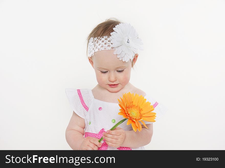 Beautiful toddler girl with flower