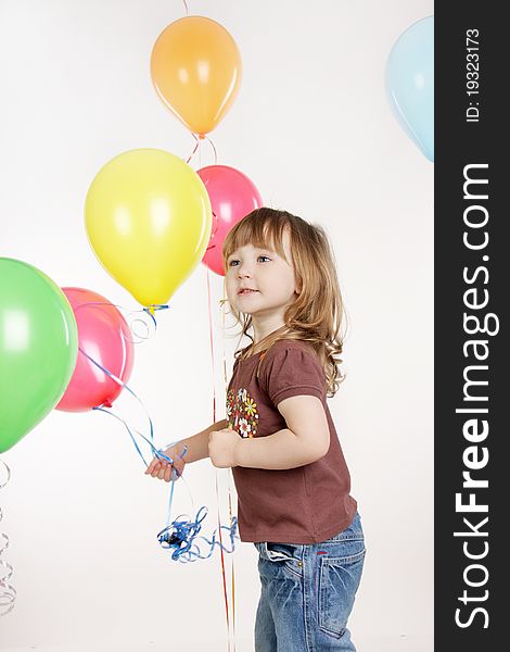Studio shot of young girl with colorful balloons