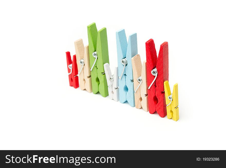 Multi colored wooden pegs in a row