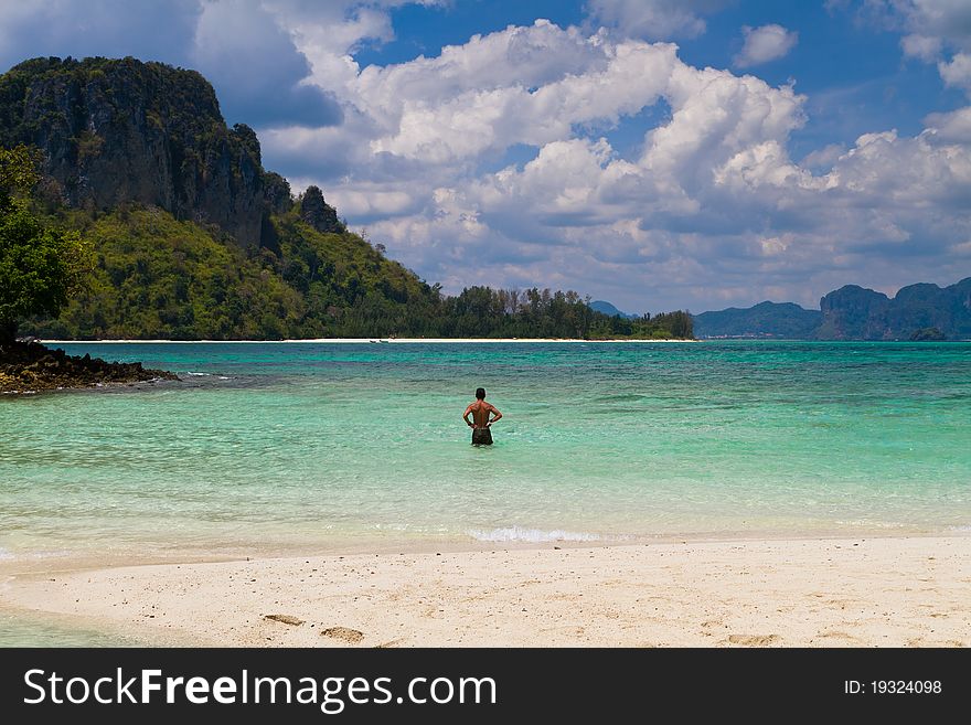 Man walking in water of exotic beach in Krabi Thailand Asia. Man walking in water of exotic beach in Krabi Thailand Asia