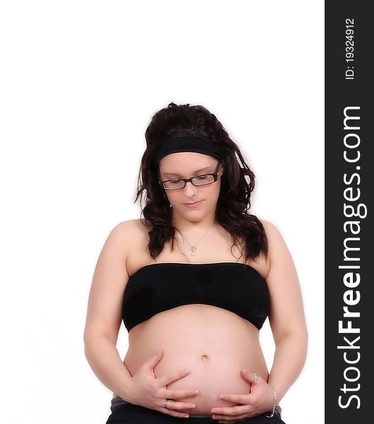Gorgeous pregnant woman with hands on bare stomach looking down. isolated on white. Gorgeous pregnant woman with hands on bare stomach looking down. isolated on white
