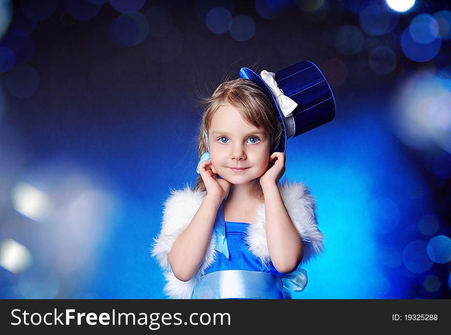 A fairy-tale girl is in dark blue clothes and hat
