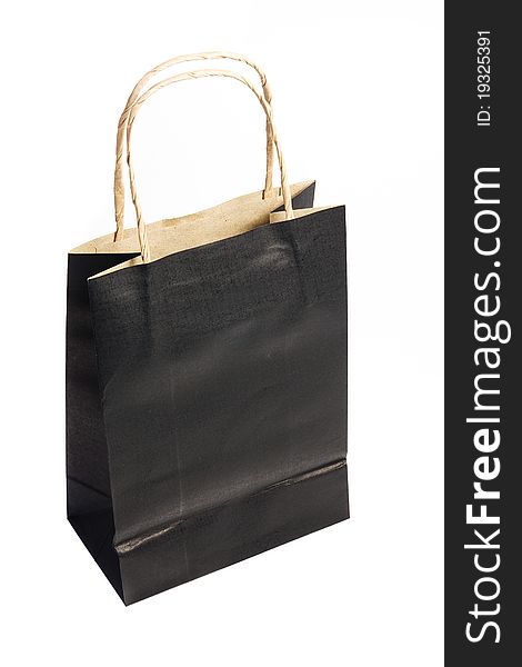 Black paper shopping bag isolated on a white background.