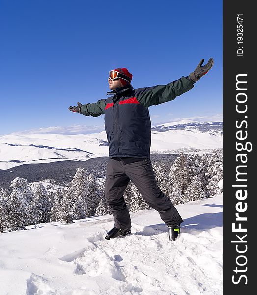 Happy skier on the top of mountain. Sarikamis, turkish ski resort.