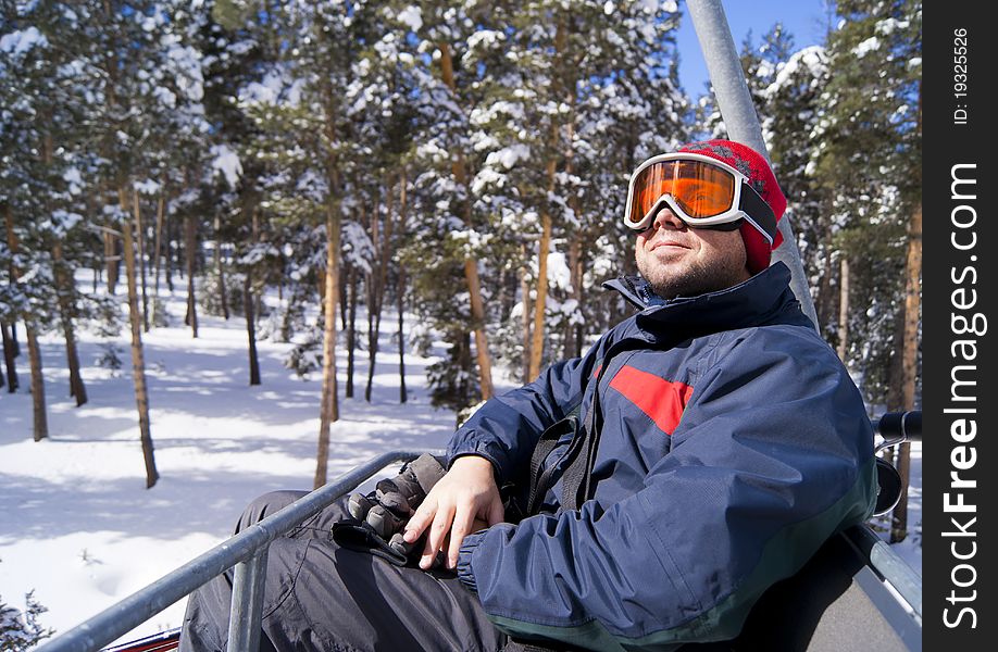 Young man is sitting on the chairlift. Sarikamis, turkish ski resort. Young man is sitting on the chairlift. Sarikamis, turkish ski resort.