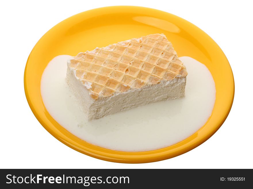 Melting ice cream in a yellow plate isolated on white background