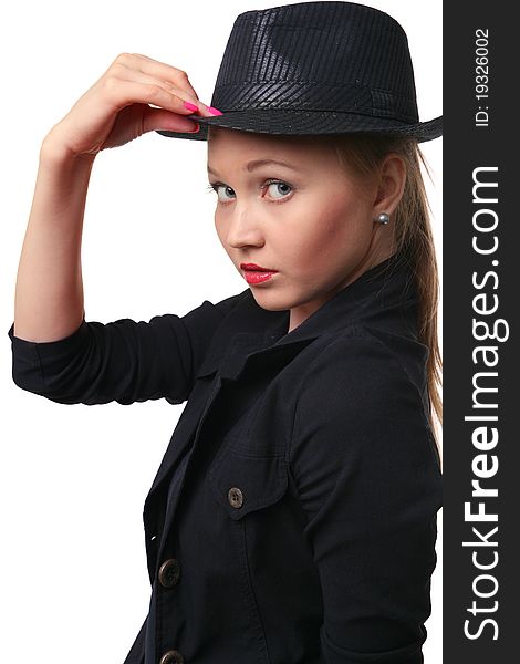 Beautiful young woman holds her hat bolder. Looking to camera.