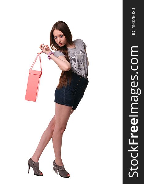 Portrait of pretty girl in grey shirt and shorts posing with bag. Portrait of pretty girl in grey shirt and shorts posing with bag.