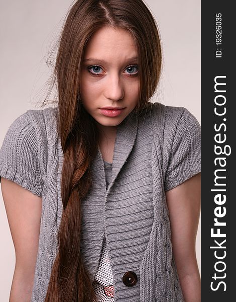 Closeup portrait of pretty girl in grey woolen shirt.