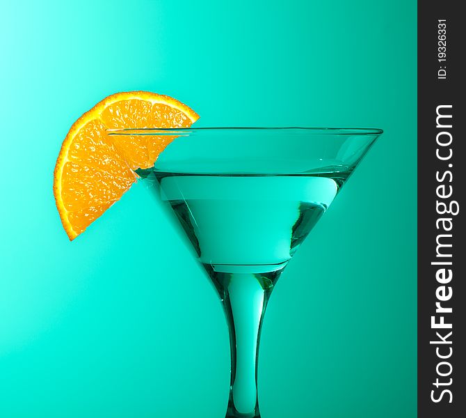 Glass With Juice And Lemon On The Green Background