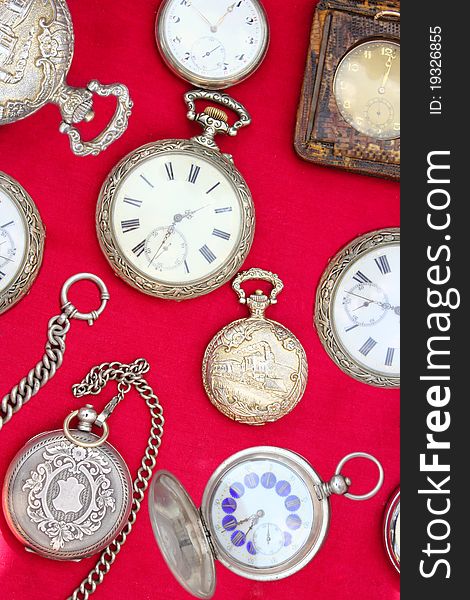 Old pocket watch close up on a red background