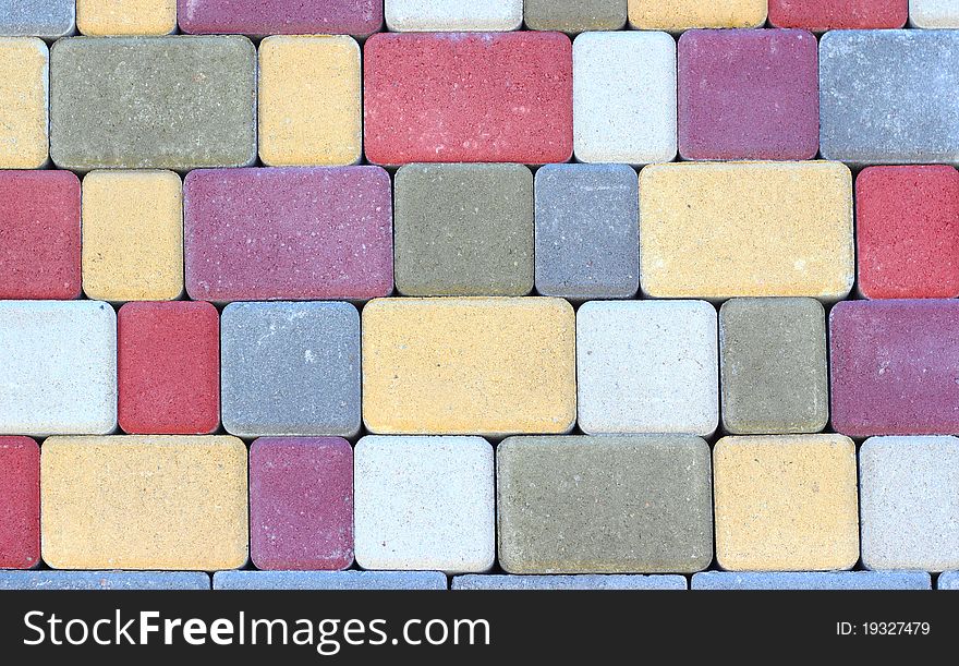 Artificial multi-colored rectangular stone close up. Artificial multi-colored rectangular stone close up