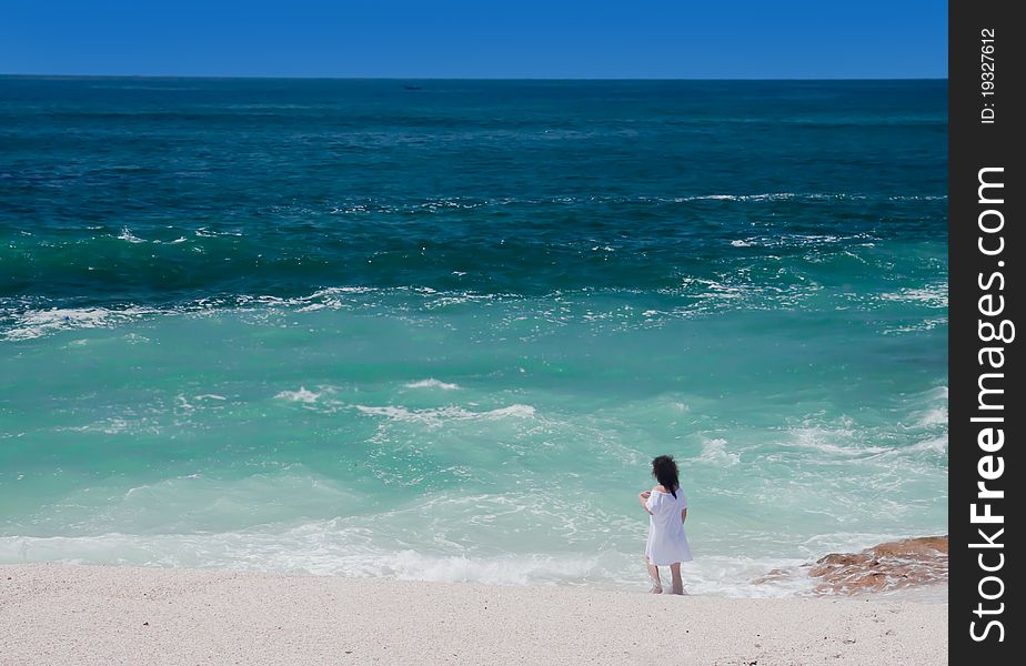 Girl standing on the tropical beach