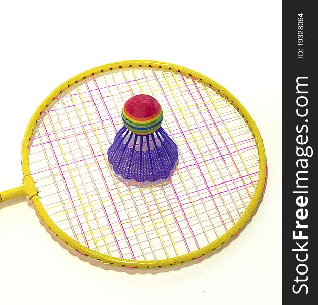 Yellow badminton racket with purple shuttlecock on white background. Yellow badminton racket with purple shuttlecock on white background