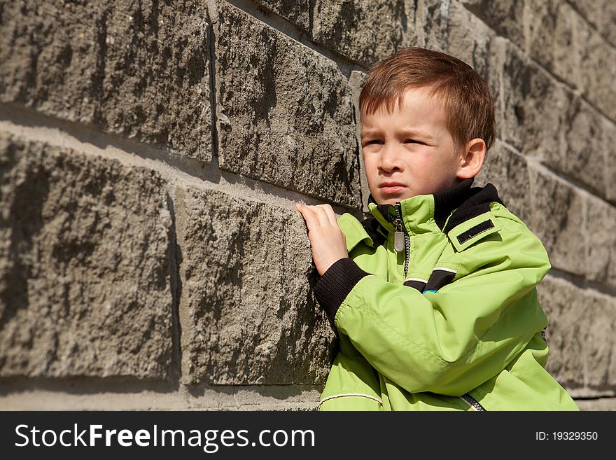 Portrait of boy about gray wall, outdoor. Portrait of boy about gray wall, outdoor