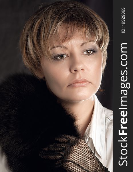 Portrait of beautiful woman wearing gloves and black fur. Portrait of beautiful woman wearing gloves and black fur