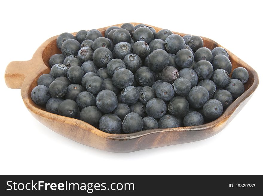 Fresh blueberries in the wooden dish