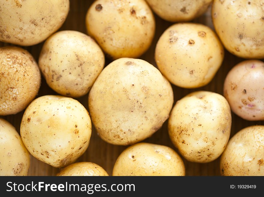 A lot of fresh raw potatoes, close-up. A lot of fresh raw potatoes, close-up