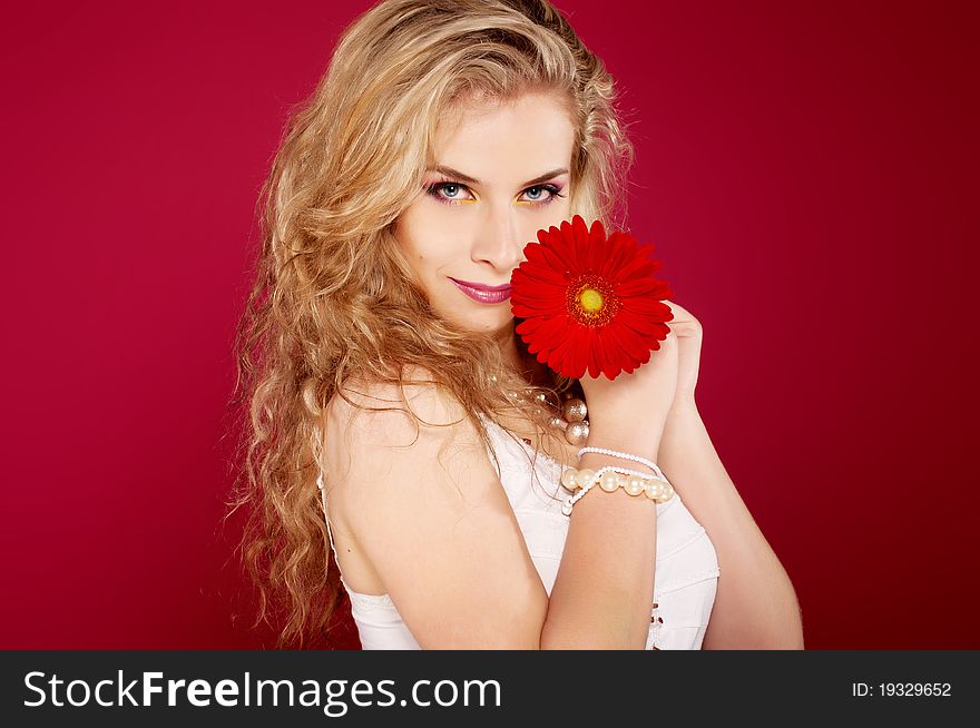 Spring concept - playful girls with flower and pink wall