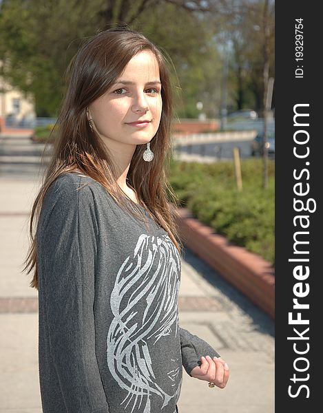 Teenage girl in Poland. Young female model posing for photos on the street. Wearing casual clothes, kind face with gentle smile. Teenage girl in Poland. Young female model posing for photos on the street. Wearing casual clothes, kind face with gentle smile.