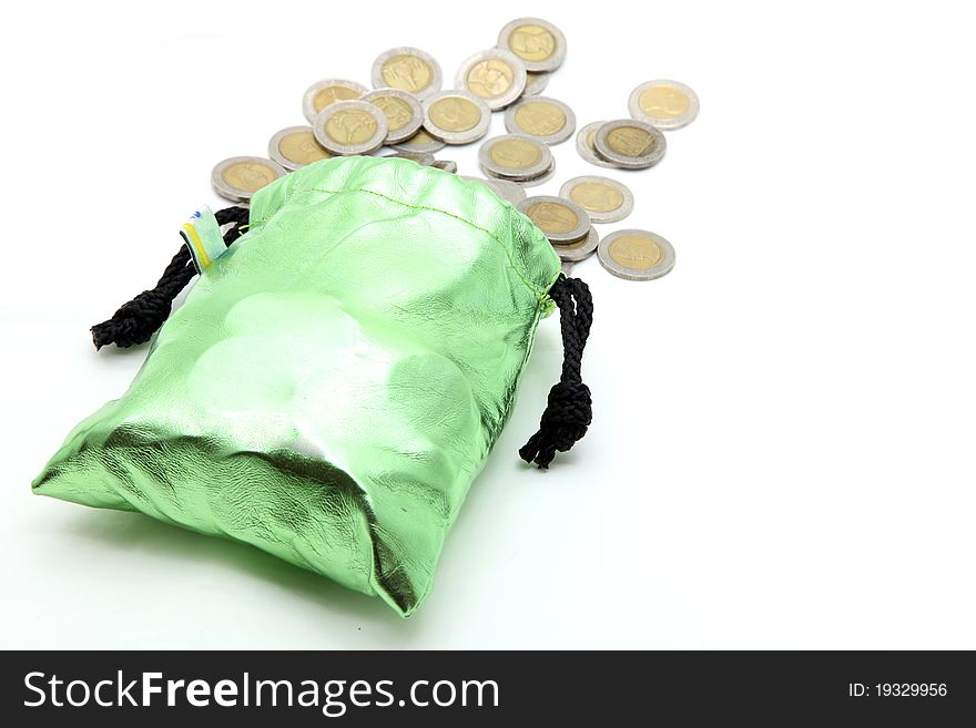 Coins spilling out from green money bag or purse isolated on white. Coins spilling out from green money bag or purse isolated on white