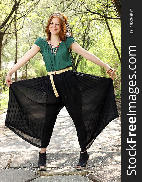 A beautiful red hair woman showing her crop pants. A beautiful red hair woman showing her crop pants.