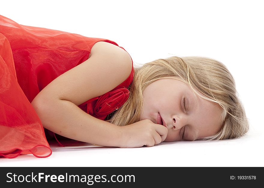 Little girl sleeping in a red dress on a white background. Little girl sleeping in a red dress on a white background.