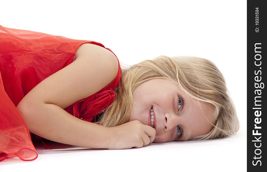 Little girl lying down in a red dress on a white background. Little girl lying down in a red dress on a white background.