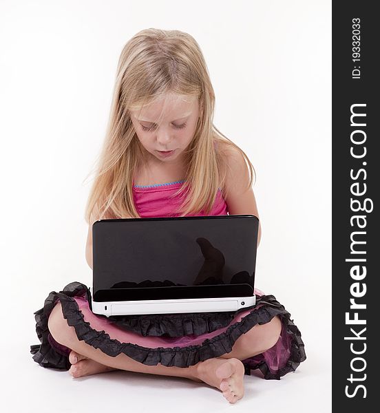 Little girl with a laptop computer on a white background. Little girl with a laptop computer on a white background.