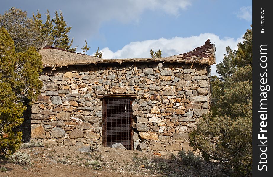 A photograph of an old mine shaft entrance.