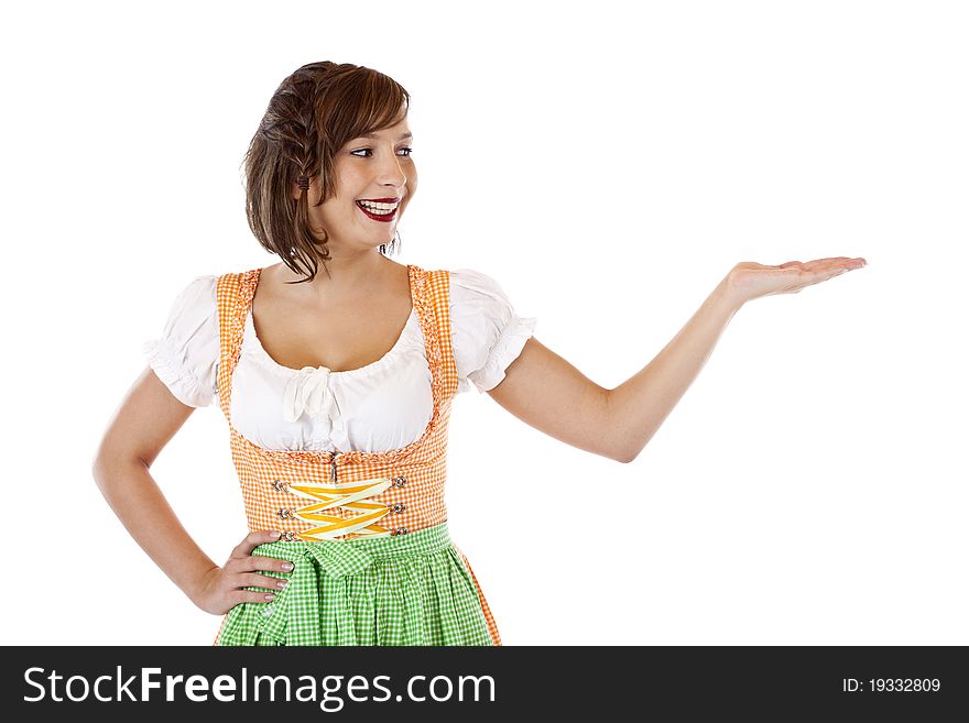 Pretty smiling woman with dirndl looks at ad space on her hand.Isolated on white background. Pretty smiling woman with dirndl looks at ad space on her hand.Isolated on white background.