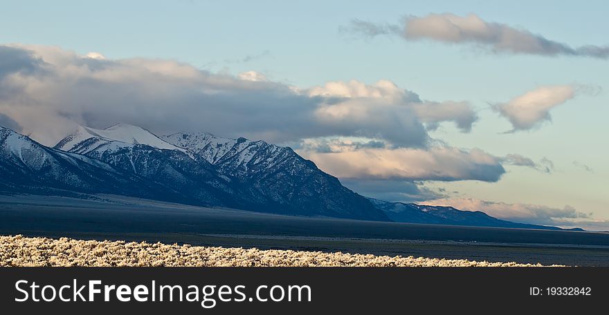 A photograph of beautiful mountains with some very stormy clouds. A photograph of beautiful mountains with some very stormy clouds.