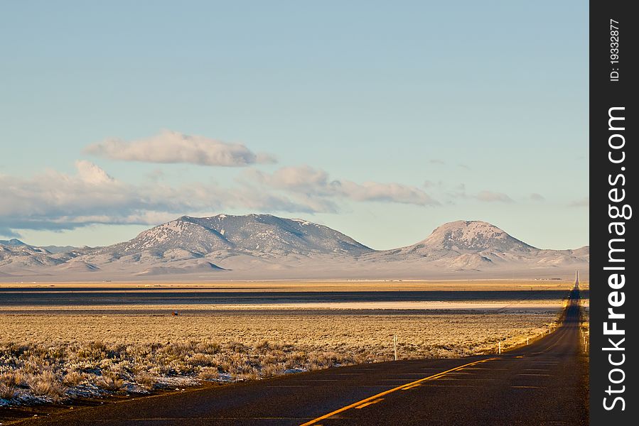 A photograph of a frontage road in Austing NV.  The mountiain is shaped nicely. A photograph of a frontage road in Austing NV.  The mountiain is shaped nicely.