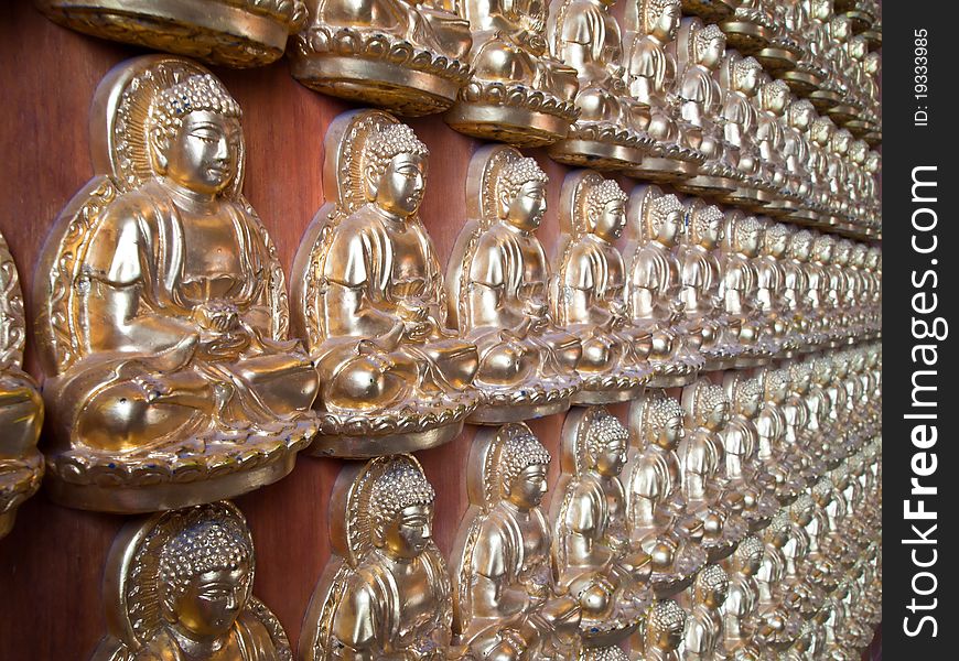 Many small Buddha statue on the wall