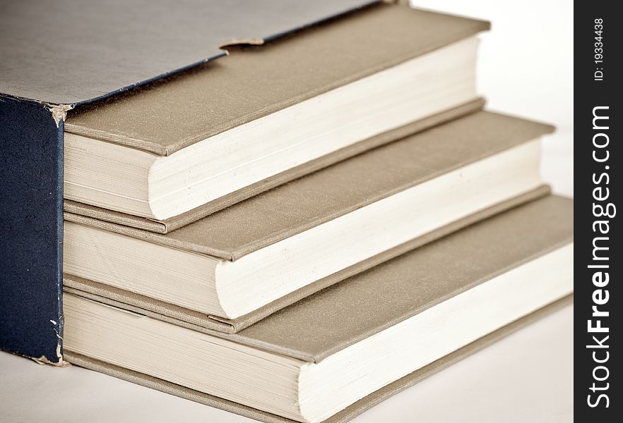 Three grey books in the box  on material background