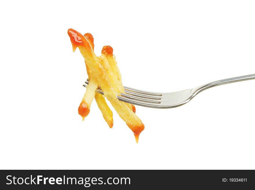 French fries dipped in tomato sauce on a fork isolated against white