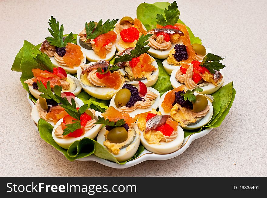Stuffed eggs with pastes with caviar, fish and olives