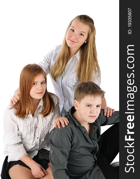Three sitting teens. Isolated, white background