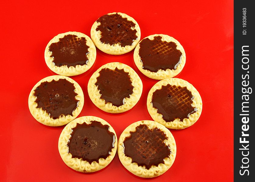 Sweet cookies with chocolate in red background. Sweet cookies with chocolate in red background