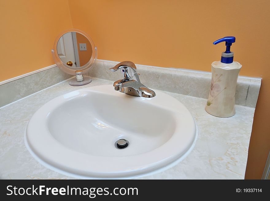 Luxurious white wash basin with mirror and hand soap. Luxurious white wash basin with mirror and hand soap.