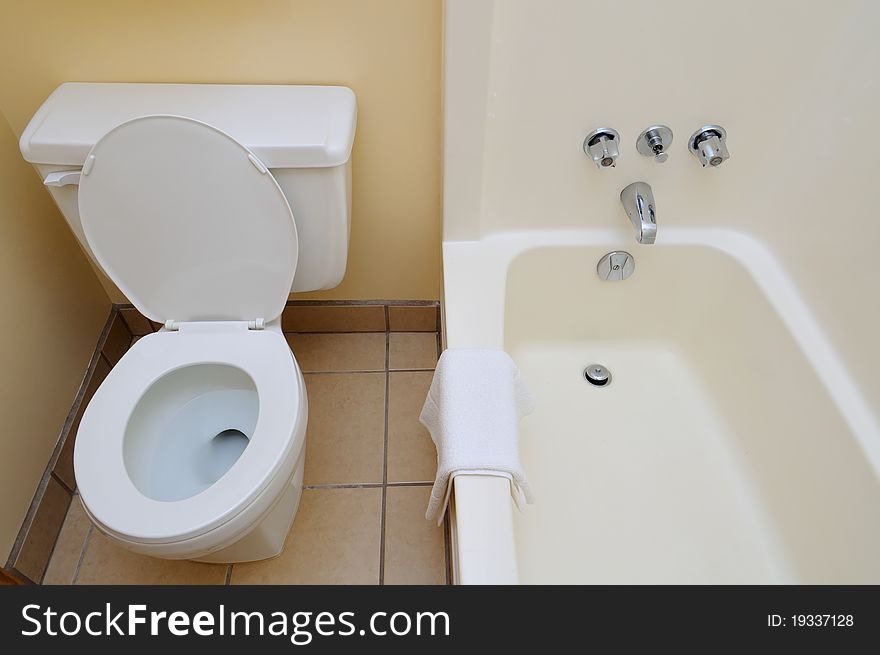 Bright and white washroom showing toilet and shower area.